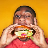man eating hamburger - junk food stock pictures, royalty-free photos & images