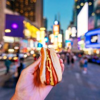man eating hot dog at times square, personal perspective view, new york, usa - food stock pictures, royalty-free photos & images