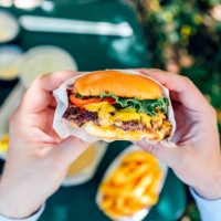 man eating juicy cheeseburger, personal perspective view - junk food stock pictures, royalty-free photos & images