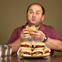 man eating many burgers - junk food stock pictures, royalty-free photos & images
