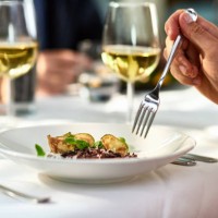 man eating meal at table with fork - food stock pictures, royalty-free photos & images