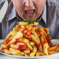 man eating very large plate of fries - junk food stock pictures, royalty-free photos & images