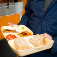 Man holding a takeaway all day breakfast in a polystyrene container on the 21st June 2008 in Victoria in the United Kingdom.