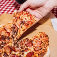man holding pizza slice - junk food stock pictures, royalty-free photos & images