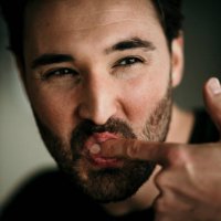 man licking index finger - food stock pictures, royalty-free photos & images