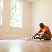 man looking at blueprints in empty room - home decoration stock pictures, royalty-free photos & images