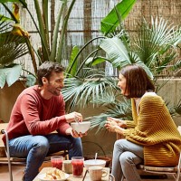 man looking at woman while having breakfast - garden decoration photos et images de collection