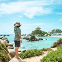 man looking towards cabo san juan beach in tayrona national park in colombia - travel stock pictures, royalty-free photos & images