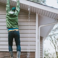man loses ladder while hanging christmas lights on house - home decoration stock pictures, royalty-free photos & images