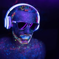 man painted in fluorescent uv colors with sunglasses and headset - fashion stock pictures, royalty-free photos & images