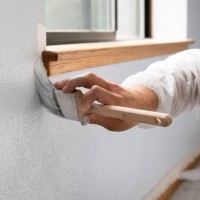 man painting interior of home by window - home decoration stock pictures, royalty-free photos & images