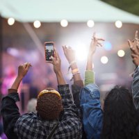man photographing through smart phone with friends - concert stock pictures, royalty-free photos & images
