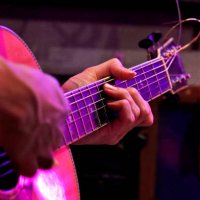 man playing an acoustic guitar on stage - concert stock pictures, royalty-free photos & images