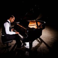 man playing piano with dramatic lighting - concert stock pictures, royalty-free photos & images