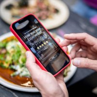 man rating his experience at a restaurant using an app on a cell phone - food stock pictures, royalty-free photos & images