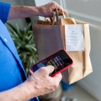 man rating his experience on the app after ordering food to his house - food stock pictures, royalty-free photos & images