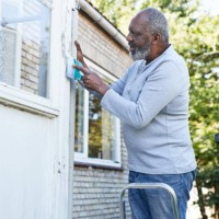 man scraping wall of house during renovation - home decoration stock pictures, royalty-free photos & images