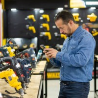 man shopping at a hardware store and taking a photo of the tools - home decoration stock pictures, royalty-free photos & images