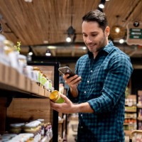 man shopping at the supermarket and scanning a label with his cell phone - food stock pictures, royalty-free photos & images