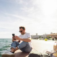 man sitting on the pier - travel stock pictures, royalty-free photos & images