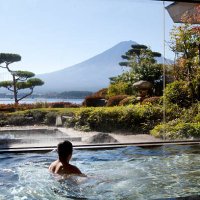 man soaking in an indoor hot spring pool - travel stock pictures, royalty-free photos & images