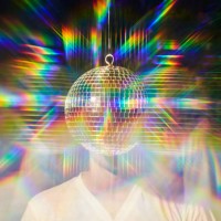 man standing behind a disco ball as if it is his head with reflective psychedelic colors. - fashion stock pictures, royalty-free photos & images