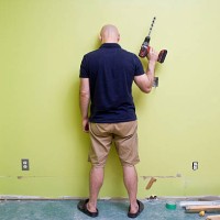 man stands looking frustrated with home renovations - home decoration stock pictures, royalty-free photos & images