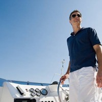 man steering a yacht - fashion stock pictures, royalty-free photos & images