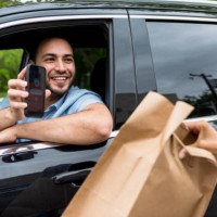 man uses mobile app to pick up food order - junk food stock pictures, royalty-free photos & images