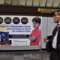 Man walks past a sign that refers to the labeling of products, in the subway of Mexico City, on October 01, 2019. - The Mexican Congress discusses...