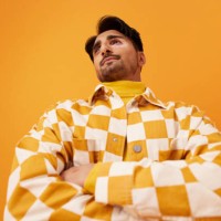 man wearing checked shirt standing with arms crossed - fashion stock pictures, royalty-free photos & images