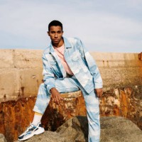 man wearing clouds denim suit staring while standing on stone - fashion stock pictures, royalty-free photos & images