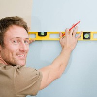 man with spirit level - home decoration stock pictures, royalty-free photos & images