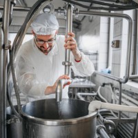 man working at a dairy factory - food stock pictures, royalty-free photos & images