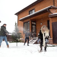 man, young woman and adult woman playing snowballs near christmas tree - garden decoration stock pictures, royalty-free photos & images