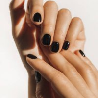 manicure on female hands with black nail polish. - nails art stock pictures, royalty-free photos & images