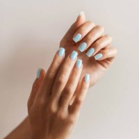 manicure on female hands with light blue nail polish. - nails art stock pictures, royalty-free photos & images