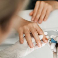manicurist doing hardware manicure to female client using special tools. - nails art stock pictures, royalty-free photos & images