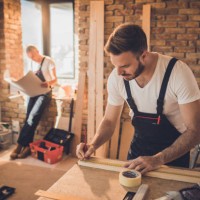 manual worker making measurements on a piece of wood at construction site. - home decoration stock pictures, royalty-free photos & images