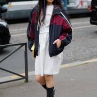 Maria Bottle wears white midi dress, blue and red Miu Miu jacket, grey Miu Miu socks, silver heels, outside Miu Miu, during the Womenswear...