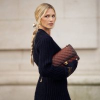 Maria Helena Bordon Meireles wears blue knitted top, brown Chanel belt, Brown Chanel bag, gold Chanel necklace outside the Chanel show during...