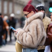 Marianne Theodorsen wears sunglasses, golden earrings, a brown / beige fluffy oversized faux fur winter coat, outside The Garment, during the...