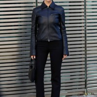 Marie Gaguech wears black leather Courrèges jacket, black trousers, black Courrèges bag, outside Courrèges, during the Womenswear Fall/Winter...