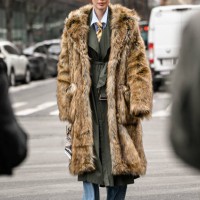 Marina Ingvarsson is seen wearing a tan faux fur coat, green coat, blue jeans and black sunglasses outside the Michael Kors show during NYFW F/W 2025...