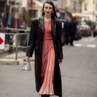 Mary Leest wears striped red and grey long maxi dress, black shoes, black coat and white Hermes bag outside Akris during the Womenswear Fall/Winter...