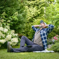 mature adult man gardener working in the garden - garden decoration stock pictures, royalty-free photos & images