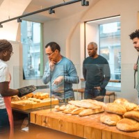 mature asian buying freshly baked goods in a bakery - junk food stock pictures, royalty-free photos & images