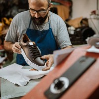 mature cobbler showing of his new product - fashion stock pictures, royalty-free photos & images