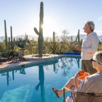 mature couple relax at desert swimming pool - travel stock pictures, royalty-free photos & images
