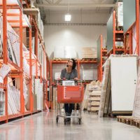 mature female customer looking up while pushing shopping cart in hardware store - home decoration stock pictures, royalty-free photos & images